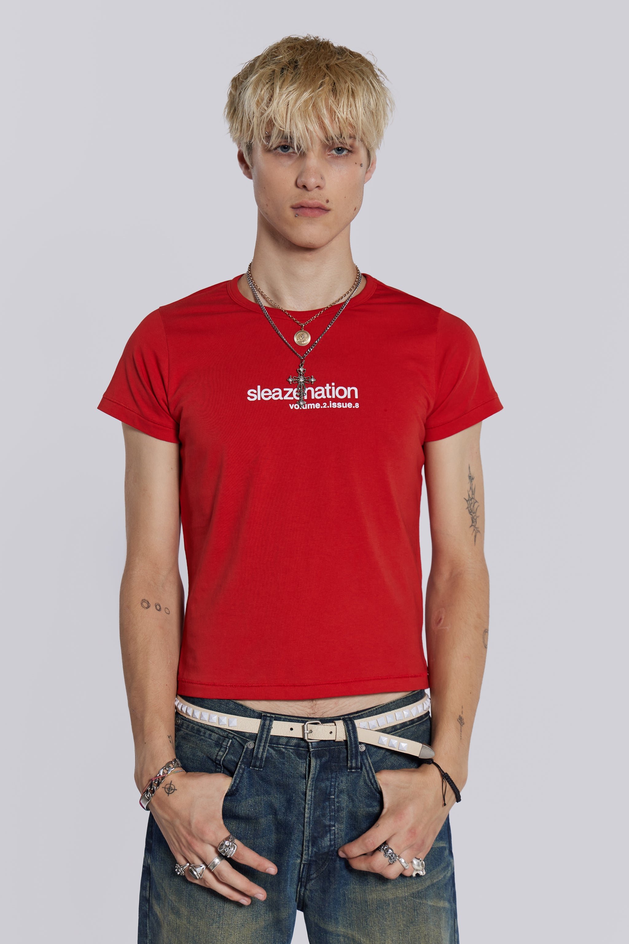 Male model wearing red shrunken short sleeve t-shirt, with Sleazenation printed graphic.