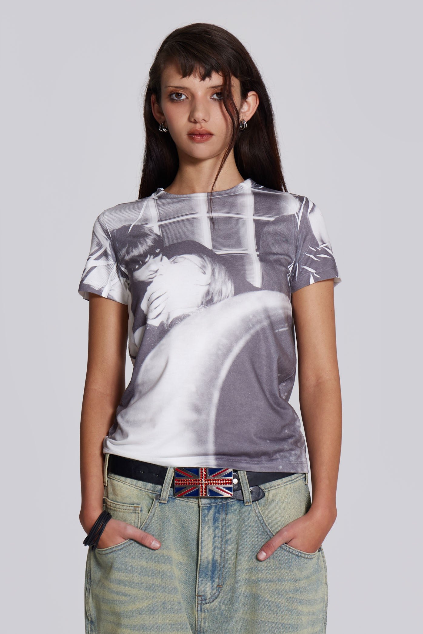 Female model wearing shrunken short sleeve t-shirt, with couple kissing graphic print.