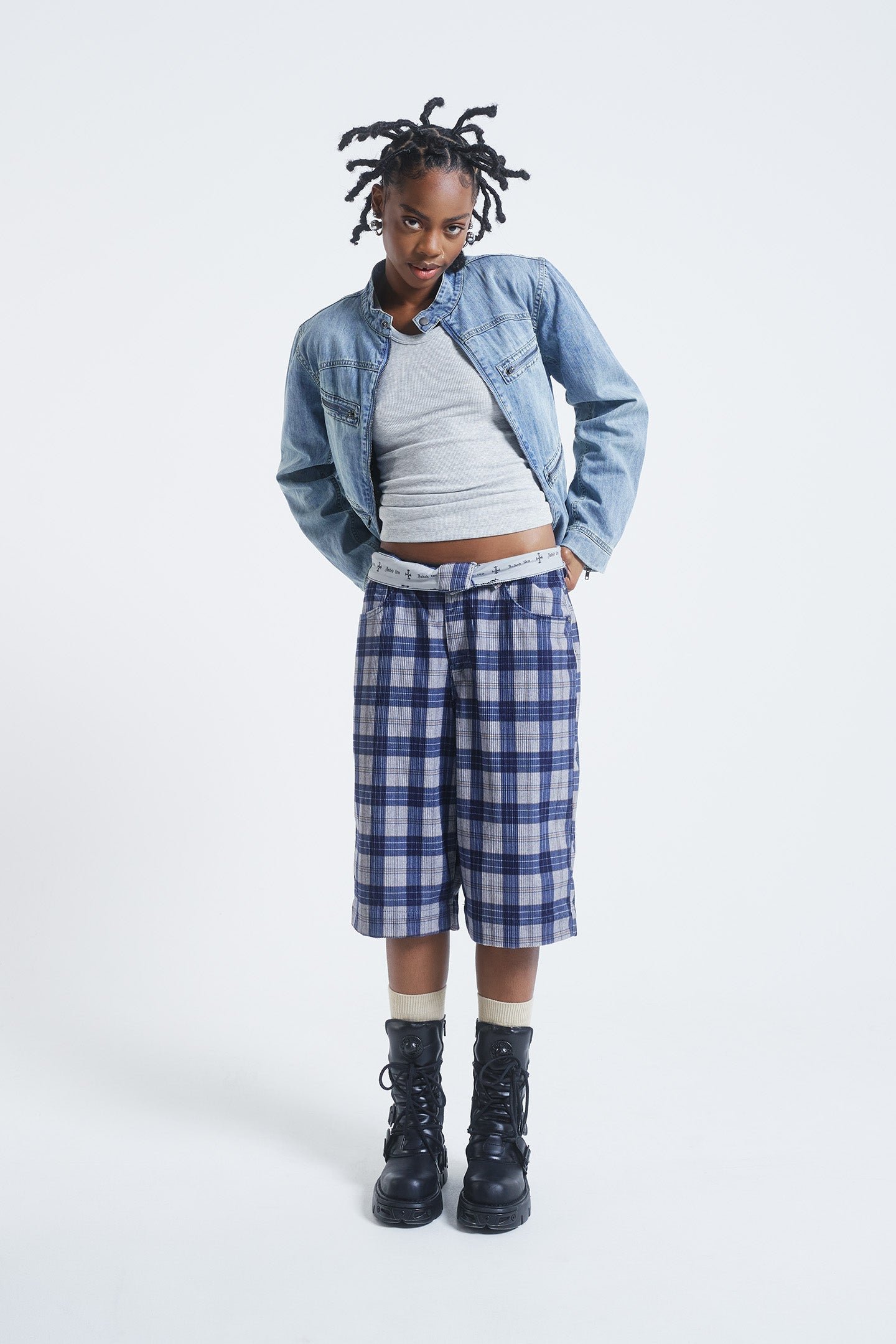 Female model wearing blue checked cord jorts in a jumbo fit. 